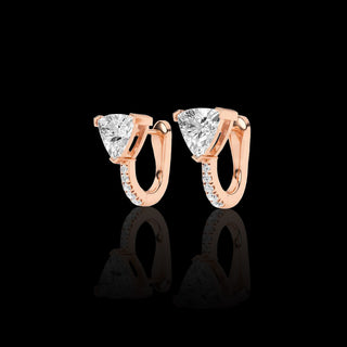 Lab-grown diamond huggie earrings with trillion and pave designs, featuring 1.5 carats total weight in vibrant pink gold.