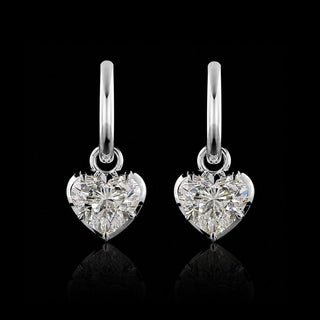 A pair of white gold huggie earrings with 1 carat each heart lab grown diamond drops in a georgian bezel-prong setting.
