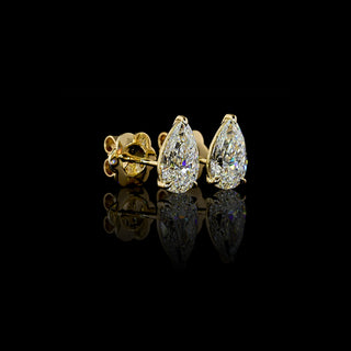 Angled side view of Pear-shaped lab grown diamond stud earrings in 14k yellow gold, claw prong setting, 2 carats total (1 carat each).