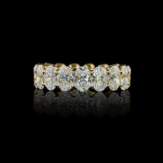 Oval lab grown diamond eternity band in 14k yellow gold, prong setting, 5 carats total.