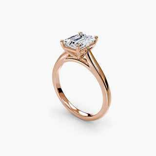 Cathedral solitaire engagement ring setting in rose gold with an emerald-cut lab grown diamond, three-quarter view. || #metal_rose gold #diamond shape_emerald