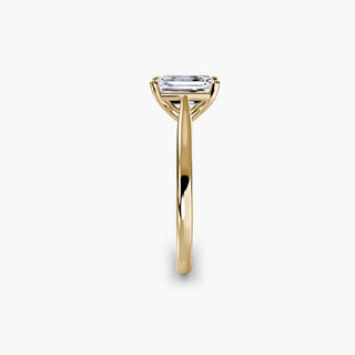 Cathedral solitaire engagement ring setting in yellow gold showing the tapered band profile, with an emerald-cut lab grown diamond. || #metal_yellow gold #diamond shape_emerald