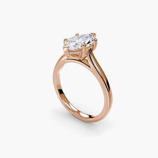 Cathedral solitaire engagement ring setting in rose gold with a marquise-cut lab grown diamond, three-quarter view. || #metal_rose gold #diamond shape_marquise