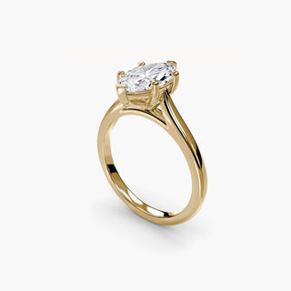 Cathedral solitaire engagement ring setting in yellow gold with a marquise-cut lab grown diamond, three-quarter view. || #metal_yellow gold #diamond shape_marquise