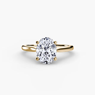 Cathedral solitaire engagement ring setting in yellow gold, featuring an oval-cut lab grown diamond. || #metal_yellow gold #diamond shape_oval