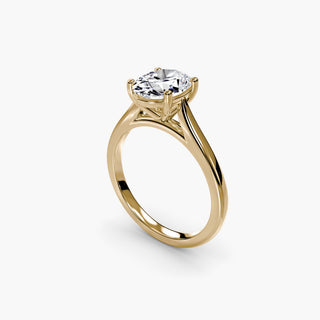 Cathedral solitaire engagement ring setting in yellow gold with an oval-cut lab grown diamond, three-quarter view. || #metal_yellow gold #diamond shape_oval