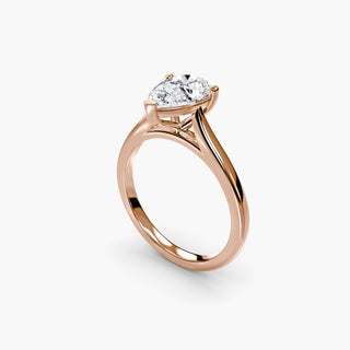 Cathedral solitaire engagement ring setting in rose gold with a pear-shaped lab grown diamond, three-quarter view. || #metal_rose gold #diamond shape_pear