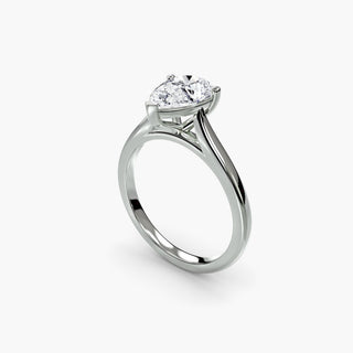 Cathedral solitaire engagement ring setting in white gold with a pear-shaped lab grown diamond, three-quarter view. || #metal_white gold|platinum #diamond shape_pear