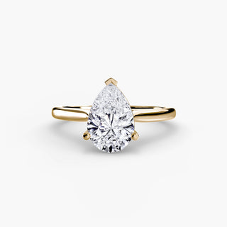 Cathedral solitaire engagement ring setting in yellow gold, featuring a pear-shaped lab grown diamond. || #metal_yellow gold #diamond shape_pear
