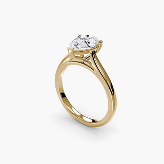 Cathedral solitaire engagement ring setting in yellow gold with a pear-shaped lab grown diamond, three-quarter view. || #metal_yellow gold #diamond shape_pear