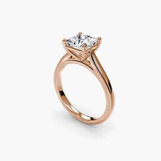 Cathedral solitaire engagement ring setting in rose gold with a princess-cut lab grown diamond, three-quarter view. || #metal_rose gold #diamond shape_princess