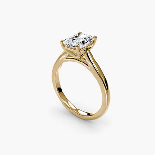 Cathedral solitaire engagement ring setting in yellow gold with a radiant-cut lab grown diamond, three-quarter view. || #metal_yellow gold #diamond shape_radiant