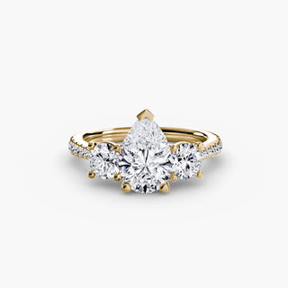 LabGrownDiamonds.com three stone cathedral pave engagement ring with pear-shaped center stone on yellow gold setting.