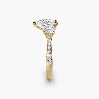Three-stone cathedral pavé engagement ring setting featuring pear-shaped lab-grown diamonds in yellow gold.