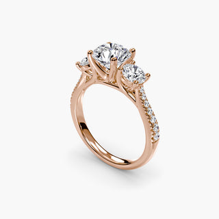 Three stone cathedral pavé engagement ring setting with round diamonds, featuring intricate metalwork and sparkling stones.