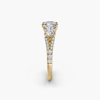 Three stone split shank pavé engagement ring setting with cushion-cut center, featuring detailed pavé band in yellow gold.