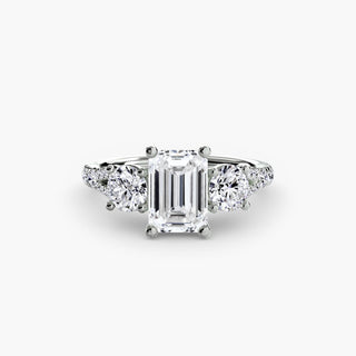 Three stone split shank pavé engagement ring setting with emerald-cut center stone and diamond accents in white gold.