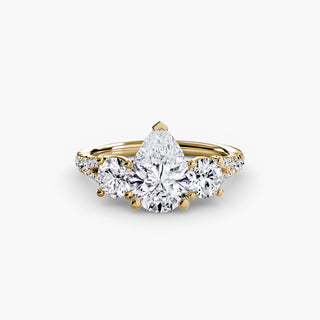 Three stone split shank pavé engagement ring setting with yellow gold finish, featuring detailed pave accents and pear-shaped center.