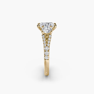 Three stone split shank pavé engagement ring setting with yellow gold finish, featuring intricate detailing and sparkling gemstones.