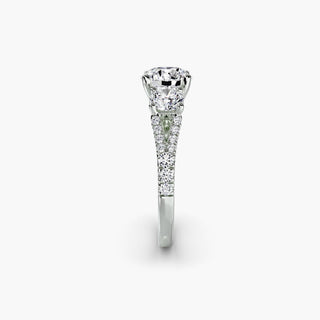 Three stone split shank pavé engagement ring setting with round diamonds in white gold. Elegant and intricate jewelry design.