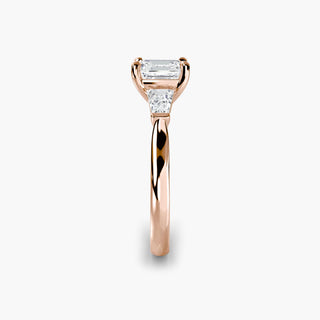 Three stone engagement ring setting in rose gold showing the band profile, with an asscher-cut lab grown center diamond and tapered baguette side stones. || #metal_rose gold #diamond shape_asscher
