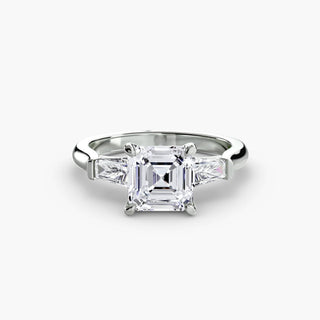 Three stone engagement ring setting in white gold, featuring an asscher-cut lab grown center diamond with tapered baguette side stones. || #metal_white gold|platinum #diamond shape_asscher