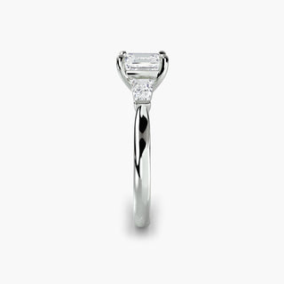 Three stone engagement ring setting in white gold showing the band profile, with an asscher-cut lab grown center diamond and tapered baguette side stones. || #metal_white gold|platinum #diamond shape_asscher