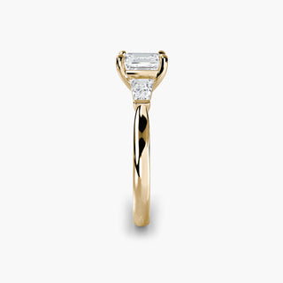 Three stone engagement ring setting in yellow gold showing the band profile, with an asscher-cut lab grown center diamond and tapered baguette side stones. || #metal_yellow gold #diamond shape_asscher