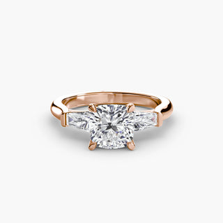 Three stone engagement ring setting in rose gold, featuring a cushion-cut lab grown center diamond with tapered baguette side stones. || #metal_rose gold #diamond shape_cushion