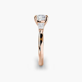 Three stone engagement ring setting in rose gold showing the band profile, with a cushion-cut lab grown center diamond and tapered baguette side stones. || #metal_rose gold #diamond shape_cushion