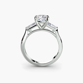 Three stone engagement ring setting in white gold, side profile view with a cushion-cut lab grown center diamond and tapered baguette side stones. || #metal_white gold|platinum #diamond shape_cushion