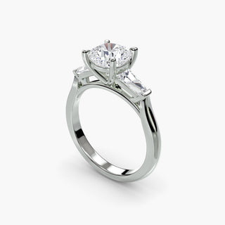 Three stone engagement ring setting in white gold with a cushion-cut lab grown center diamond and tapered baguette side stones, three-quarter view. || #metal_white gold|platinum #diamond shape_cushion