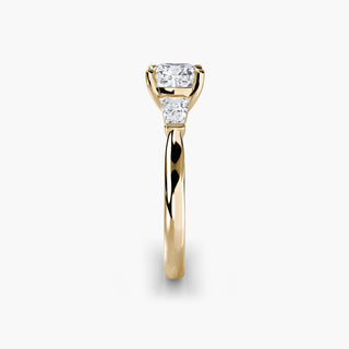 Three stone engagement ring setting in yellow gold showing the band profile, with a cushion-cut lab grown center diamond and tapered baguette side stones. || #metal_yellow gold #diamond shape_cushion