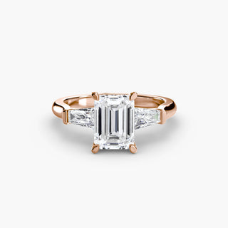 Three stone engagement ring setting in rose gold, featuring an emerald-cut lab grown center diamond with tapered baguette side stones. || #metal_rose gold #diamond shape_emerald
