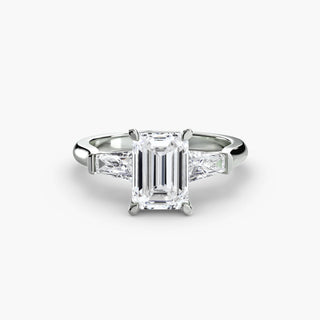 Three stone engagement ring setting in white gold, featuring an emerald-cut lab grown center diamond with tapered baguette side stones. || #metal_white gold|platinum #diamond shape_emerald