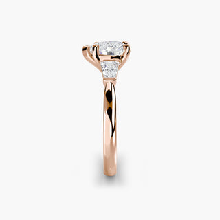 Three stone engagement ring setting in rose gold showing the band profile, with a heart-shaped lab grown center diamond and tapered baguette side stones. || #metal_rose gold #diamond shape_heart