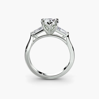 Three stone engagement ring setting in white gold, side profile view with a heart-shaped lab grown center diamond and tapered baguette side stones. || #metal_white gold|platinum #diamond shape_heart