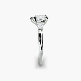 Three stone engagement ring setting in white gold showing the band profile, with a heart-shaped lab grown center diamond and tapered baguette side stones. || #metal_white gold|platinum #diamond shape_heart