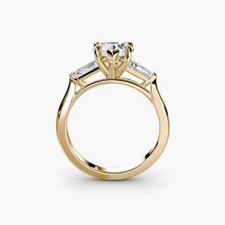 Three stone engagement ring setting in yellow gold, side profile view with a heart-shaped lab grown center diamond and tapered baguette side stones. || #metal_yellow gold #diamond shape_heart