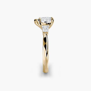 Three stone engagement ring setting in yellow gold showing the band profile, with a heart-shaped lab grown center diamond and tapered baguette side stones. || #metal_yellow gold #diamond shape_heart
