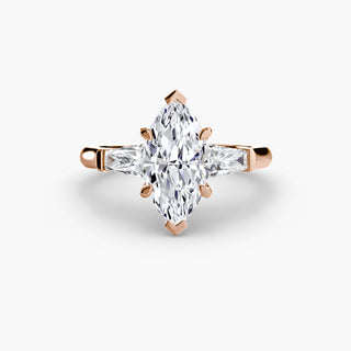 Three stone engagement ring setting in rose gold, featuring a marquise-cut lab grown center diamond with tapered baguette side stones. || #metal_rose gold #diamond shape_marquise