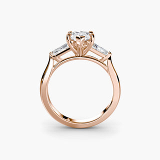 Three stone engagement ring setting in rose gold, side profile view with a marquise-cut lab grown center diamond and tapered baguette side stones. || #metal_rose gold #diamond shape_marquise