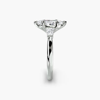 Three stone engagement ring setting in white gold showing the band profile, with a marquise-cut lab grown center diamond and tapered baguette side stones. || #metal_white gold|platinum #diamond shape_marquise
