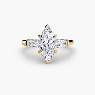 Three stone engagement ring setting in yellow gold, featuring a marquise-cut lab grown center diamond with tapered baguette side stones. || #metal_yellow gold #diamond shape_marquise