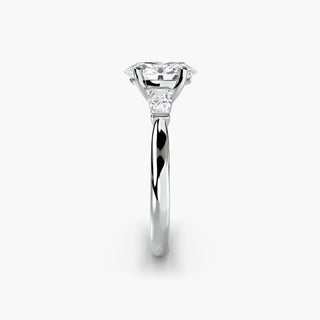Three stone engagement ring setting in white gold showing the band profile, with an oval-cut lab grown center diamond and tapered baguette side stones. || #metal_white gold|platinum #diamond shape_oval