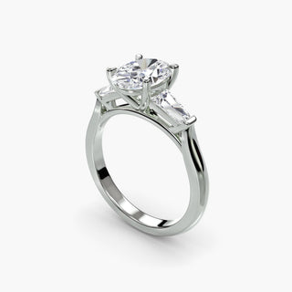 Three stone engagement ring setting in white gold with an oval-cut lab grown center diamond and tapered baguette side stones, three-quarter view. || #metal_white gold|platinum #diamond shape_oval