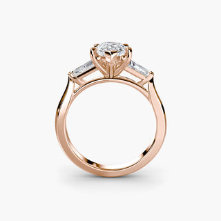 Three stone engagement ring setting in rose gold, side profile view with a pear-shaped lab grown center diamond and tapered baguette side stones. || #metal_rose gold #diamond shape_pear