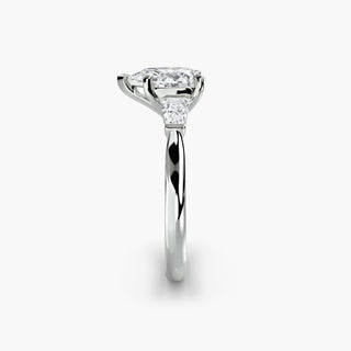 Three stone engagement ring setting in white gold showing the band profile, with a pear-shaped lab grown center diamond and tapered baguette side stones. || #metal_white gold|platinum #diamond shape_pear