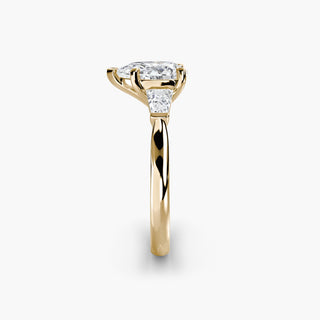 Three stone engagement ring setting in yellow gold showing the band profile, with a pear-shaped lab grown center diamond and tapered baguette side stones. || #metal_yellow gold #diamond shape_pear