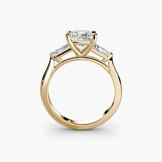 Three stone engagement ring setting in yellow gold, side profile view with a princess-cut lab grown center diamond and tapered baguette side stones. || #metal_yellow gold #diamond shape_princess